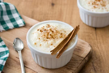 Fotobehang Arroz con leche. Rice pudding with cinnamon on wooden background   © chandlervid85