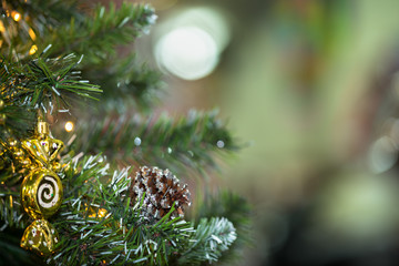 Decorations on christmas tree at night with bokeh on background, soft focus