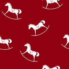 Obraz premium Seamless Pattern with a Rocking Horse , Toy on a Red Background , Vector Illustration
