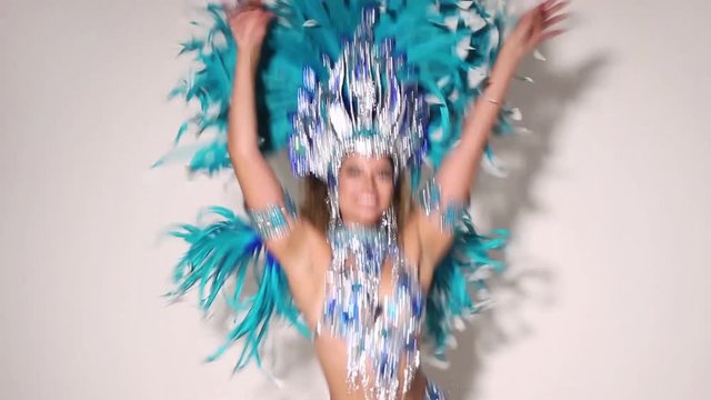 Beautiful and happy brazilian woman dancing samba while wearing traditional costume