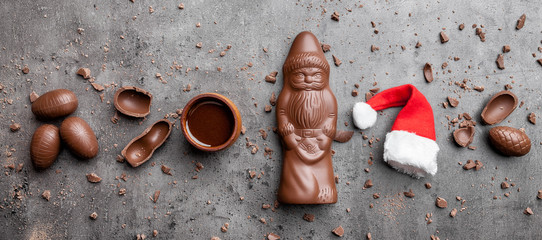 Delicious Christmas chocolate and sweets on rustic background