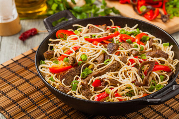 Chinese pasta with beef. Prepared in wok.