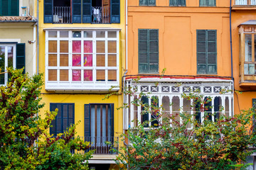 Fototapeta na wymiar Direct view of the facade of the house. Colored windows, balcony.