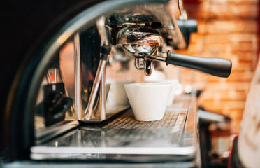 Fototapeta na wymiar Automatic espresso machine preparing fresh arabic coffee into cups