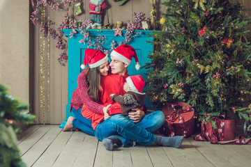 Happy family celebrates Christmas. Mom, Dad and Son in Christmas Decorations