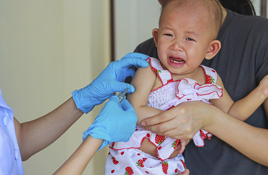 Asian baby girl crying when getting Vaccine,blurry