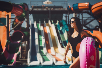 Obraz na płótnie Canvas model in black bikini on the inflatable ring in the swimming pool. Summer Vacation. Enjoying suntan. Weekend on resort