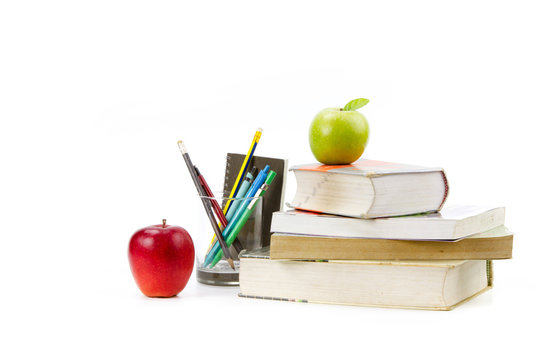 Books pens and apples isolated white background metaphor knowledge or homework and school concept.