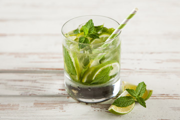 Mojito cocktail on white wood background