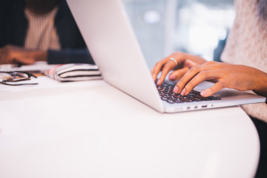 Close-up of woman typing email on laptop