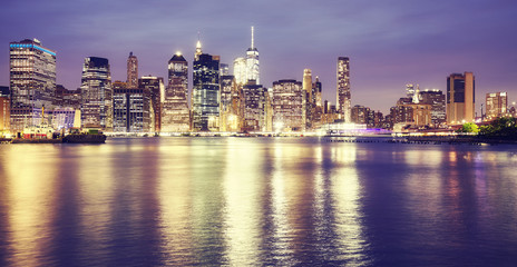 Vintage toned picture of New York City at night.