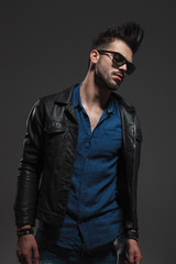 sad and dramatic fashion in leather jacket and sunglasses