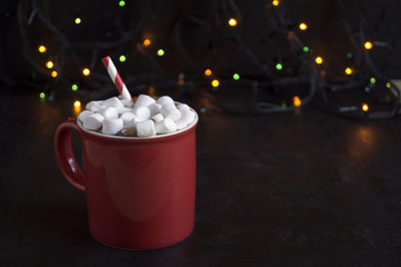 Cocoa in a red Cup and mittens.