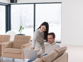 multiethnic couple using laptop computers