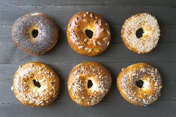 Bagels with seeds on a black background.