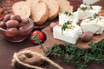Greek cheese feta with thyme and olives.  selective focus, copy space