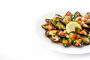 Steamed mussels with peppers and onion isolated on white background.Copyspace

