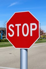 The red octagon stop sign on a close up view.