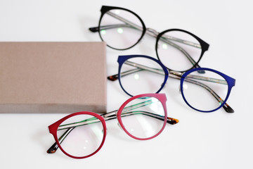 Multicolored fashionable glasses with box on white background