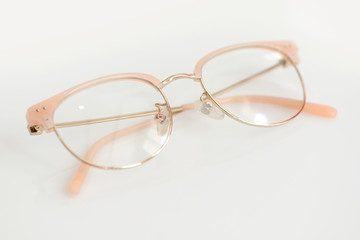 Pink glasses with clear lenses on the white background