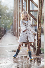 little girl enjoy happy in puddles of water