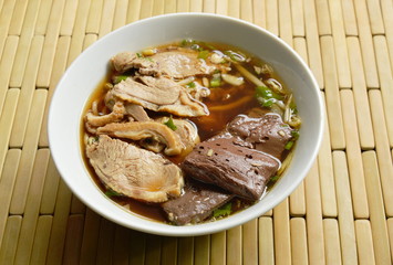 boiled duck meat and blood in brown Chinese herb soup on bowl