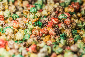 Texture background of multi-colored caramel popcorn. Close-up.