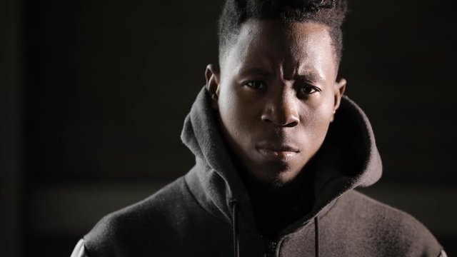 Man wearing hood in darkness