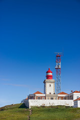 Fototapeta na wymiar Lighthouse at Cabo da Roca and a beautiful blue sky. Sintra, Portugal
