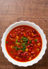 Vegetable soup with red bean, tomato on a wooden background. with copy space. top view