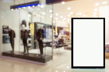 vertical light box or advertising billboard in front of fashion men clothes shop showcase in shopping mall, copy space for text or media content, advertisement, commercial and marketing concept