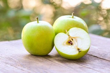 Apples on wooden table in garden