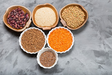 Healthy grains groats in wooden and ceramic bowls