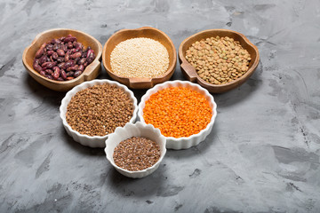Healthy grains groats in wooden and ceramic bowls