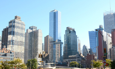 Fototapeta na wymiar Skyscrapers and apartment buildings at intersection in New York City