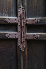Rusty iron hinge on a old wooden door