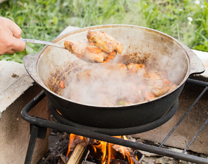 cooking in a cauldron at the stake