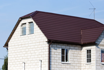 roof of a cottage house against a blue sky
