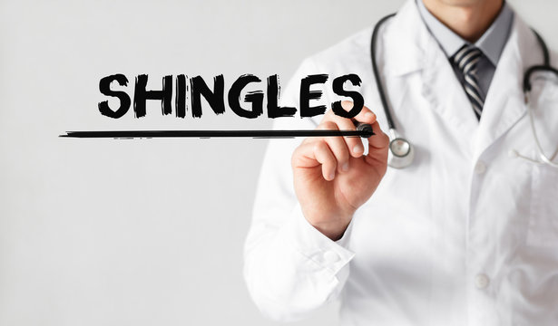 Doctor writing word Shingles with marker, Medical concept