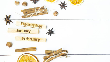 winter still life with the inscriptions of the names of the months - December, January, February among the Christmas products and ornaments. Flat lay. Background. Copyspace
