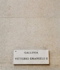 Sign to entrance of Galleria Vittorio Emanuele II, a giant arcade of fancy boutique shops in the heart of Milan, Italy