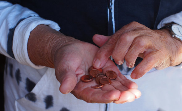 Woman hands holding some euro coins. Pension, poverty, social problems and senility theme