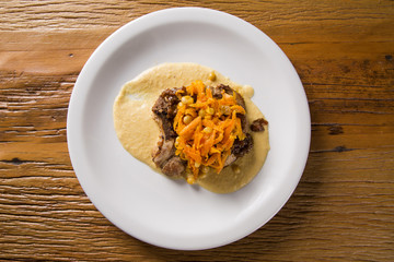pork chop with barbecue sauce and corn musseline with carrot.
