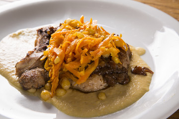 pork chop with barbecue sauce and corn musseline with carrot.
