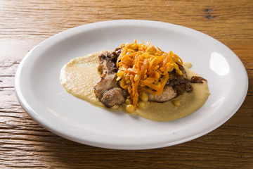 pork chop with barbecue sauce and corn musseline with carrot.