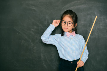 confident smart little girl dressed as teacher