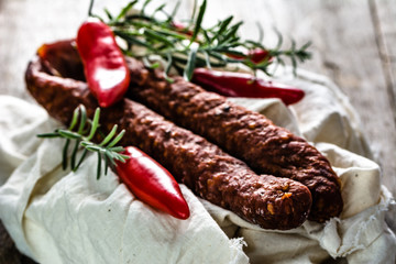 Tapas from spain, chorizo sausage or dry salami pepperoni, traditional spanish food on wooden table.