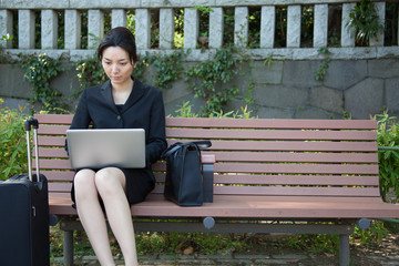 Japanese woman works with a Laptop wirelessly outdoors