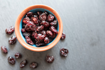 dried cranberries in bowl on slate