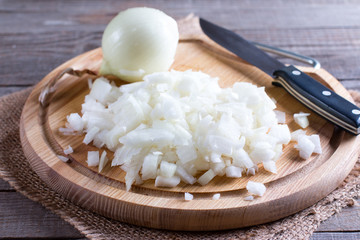 Raw onion, chopped very small cubes on a wooden board